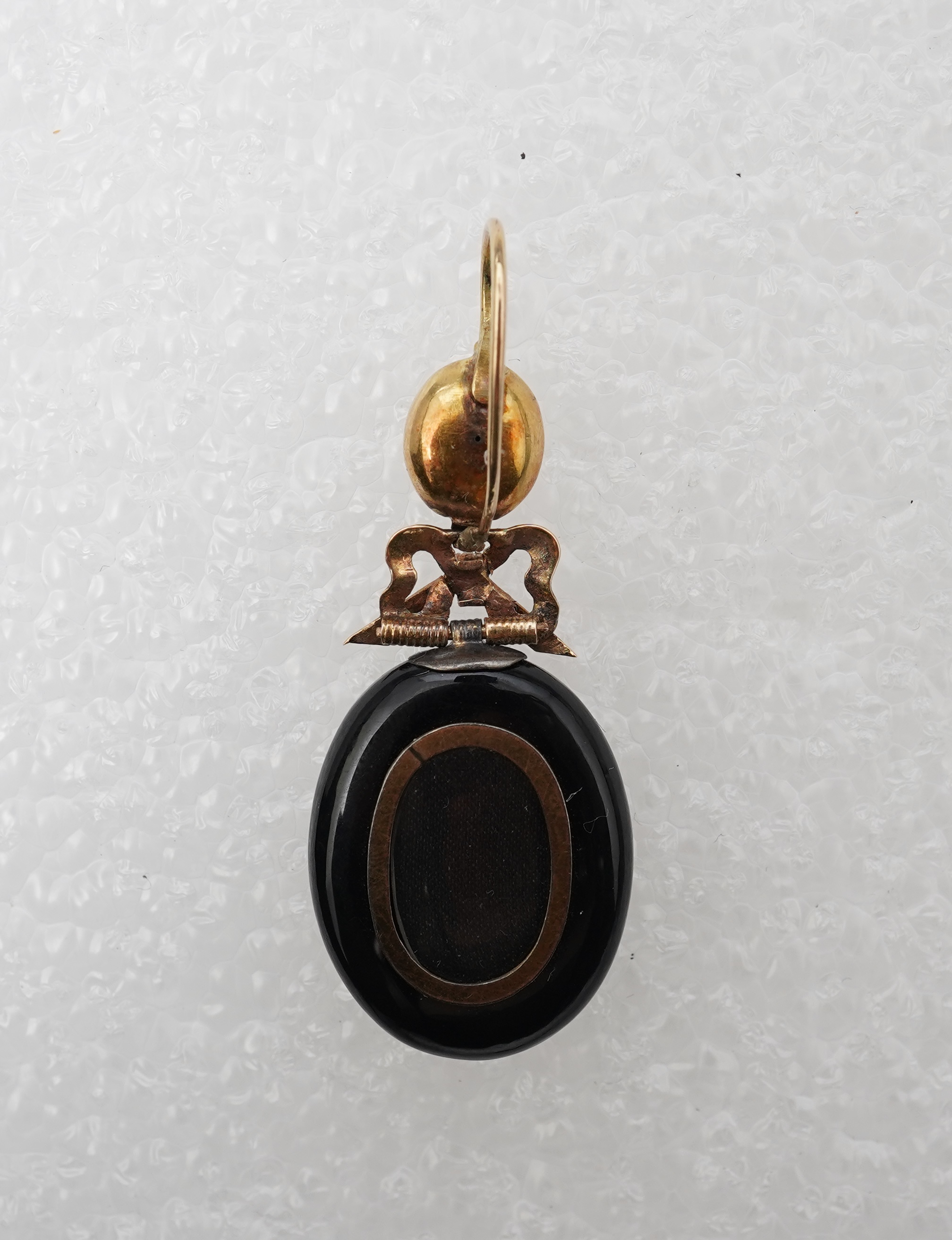 An onyx and seed pearl mourning locket pendant, late 19th century